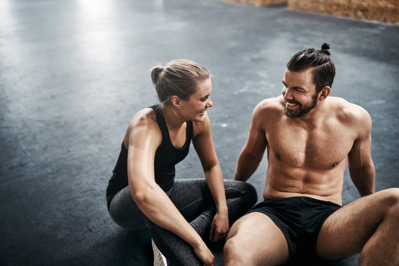 fit young couple sitting together on a health club utc
