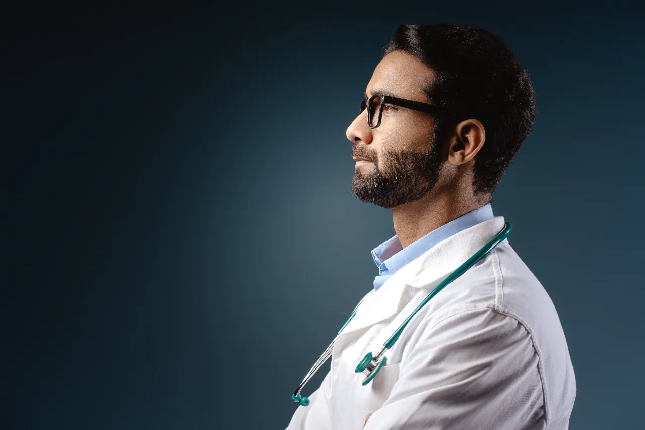 portrait of serious bearded indian man doctor we utc